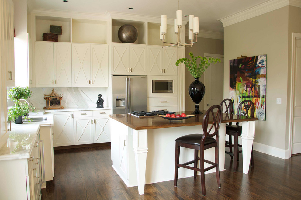 Immagine di una cucina a L chic con elettrodomestici in acciaio inossidabile, lavello a doppia vasca, ante bianche e paraspruzzi bianco