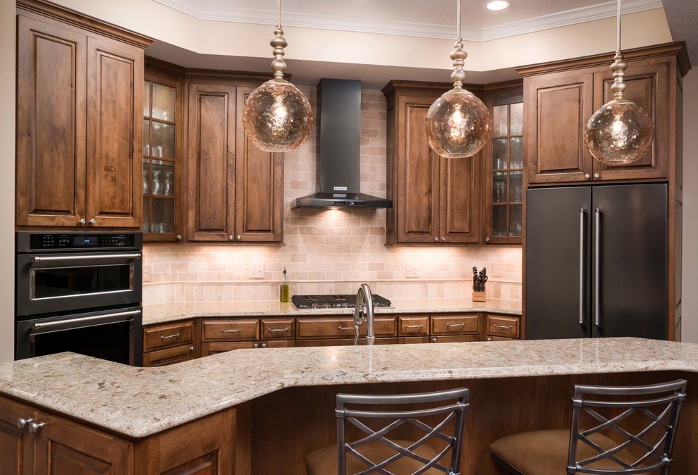 Mid-sized elegant galley dark wood floor and brown floor eat-in kitchen photo in Columbus with an undermount sink, raised-panel cabinets, distressed cabinets, quartz countertops, beige backsplash, stone tile backsplash, stainless steel appliances and an island
