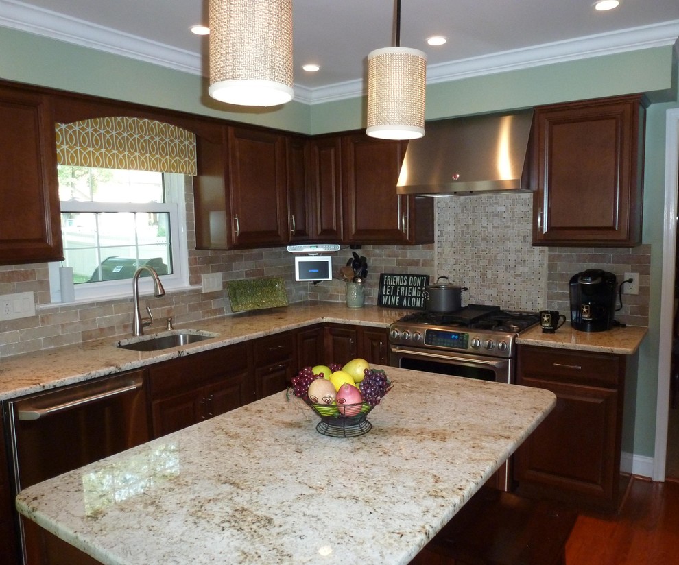 Inspiration for a mid-sized timeless l-shaped medium tone wood floor eat-in kitchen remodel in Philadelphia with an undermount sink, recessed-panel cabinets, medium tone wood cabinets, laminate countertops, beige backsplash, ceramic backsplash, stainless steel appliances and an island