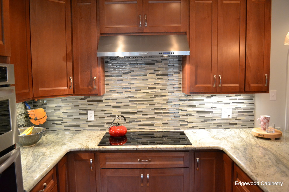 Example of an urban u-shaped medium tone wood floor kitchen design in Raleigh with recessed-panel cabinets, medium tone wood cabinets, granite countertops, matchstick tile backsplash and stainless steel appliances