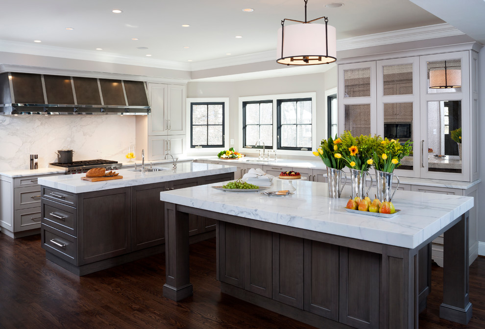 Large elegant l-shaped dark wood floor enclosed kitchen photo in DC Metro with an undermount sink, recessed-panel cabinets, gray cabinets, white backsplash, two islands, marble countertops, stainless steel appliances and stone slab backsplash
