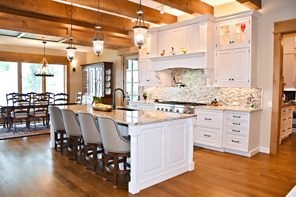 Eat-in kitchen - large traditional u-shaped medium tone wood floor and brown floor eat-in kitchen idea in Other with an undermount sink, raised-panel cabinets, white cabinets, quartzite countertops, multicolored backsplash, ceramic backsplash, stainless steel appliances, an island and beige countertops