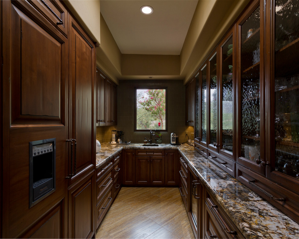 Inspiration for a classic u-shaped kitchen in Phoenix with raised-panel cabinets, dark wood cabinets and integrated appliances.
