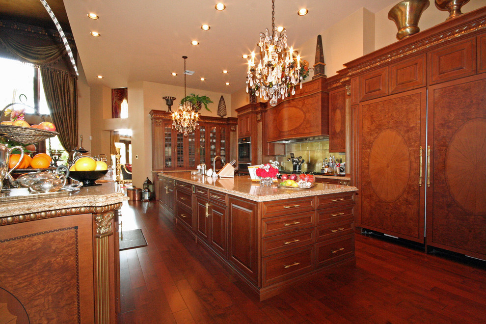 Example of a huge tuscan l-shaped medium tone wood floor eat-in kitchen design in Miami with two islands, raised-panel cabinets, medium tone wood cabinets, granite countertops and stainless steel appliances