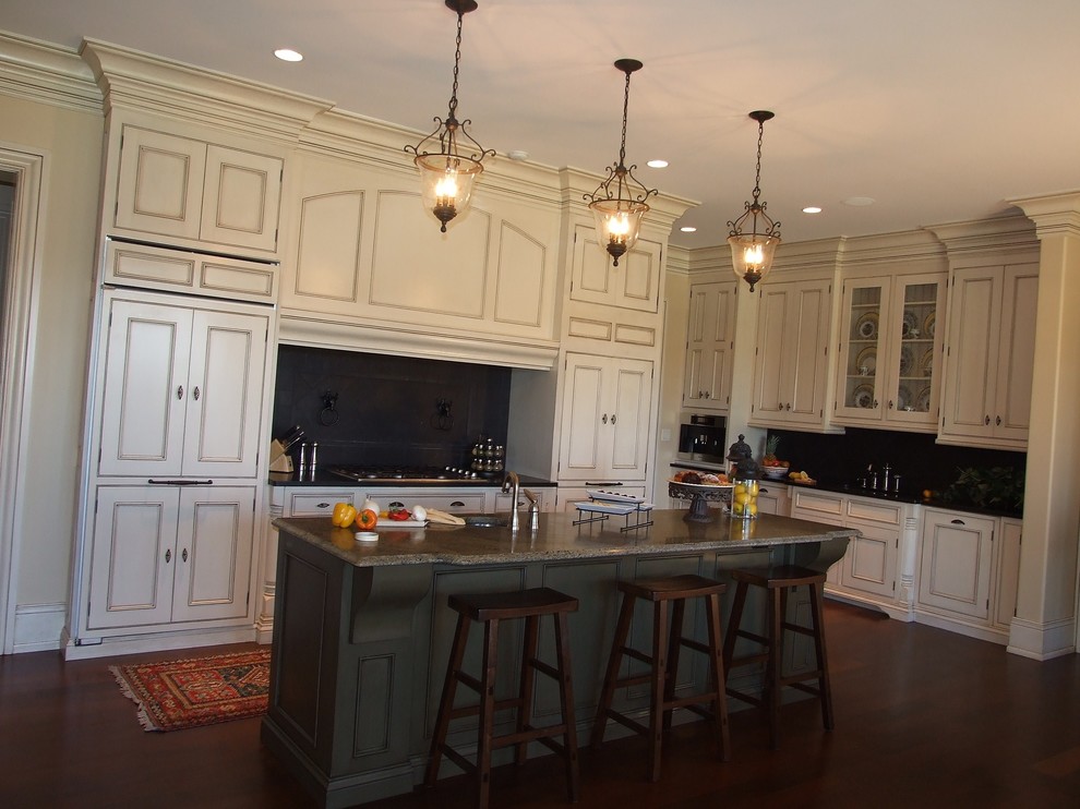 Inspiration for a large timeless u-shaped dark wood floor eat-in kitchen remodel in Louisville with white cabinets, granite countertops, black backsplash, an island, an undermount sink, recessed-panel cabinets, stone tile backsplash and white appliances