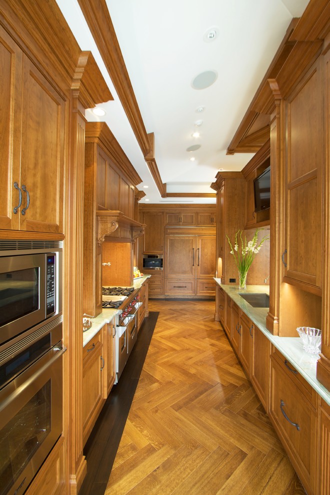 Inspiration for a classic galley enclosed kitchen in Miami with medium wood cabinets.