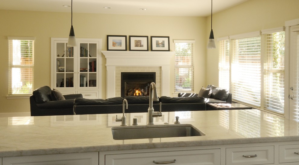 Large elegant u-shaped medium tone wood floor open concept kitchen photo in Sacramento with an undermount sink, recessed-panel cabinets, white cabinets, quartzite countertops, beige backsplash, ceramic backsplash, stainless steel appliances and a peninsula