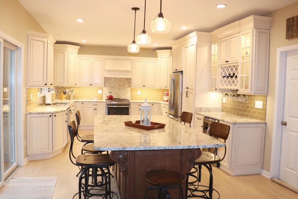 Example of a mid-sized classic u-shaped porcelain tile and gray floor eat-in kitchen design in New York with a single-bowl sink, raised-panel cabinets, beige cabinets, granite countertops, green backsplash, glass tile backsplash, stainless steel appliances, an island and gray countertops