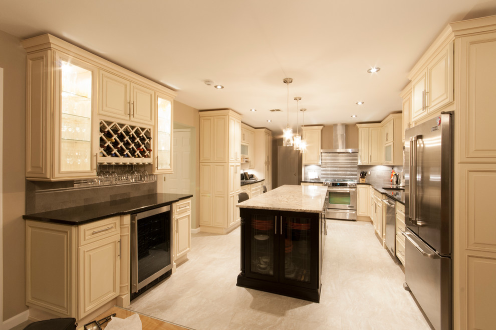 Example of a classic galley eat-in kitchen design in New York with an undermount sink, raised-panel cabinets, beige cabinets and stainless steel appliances