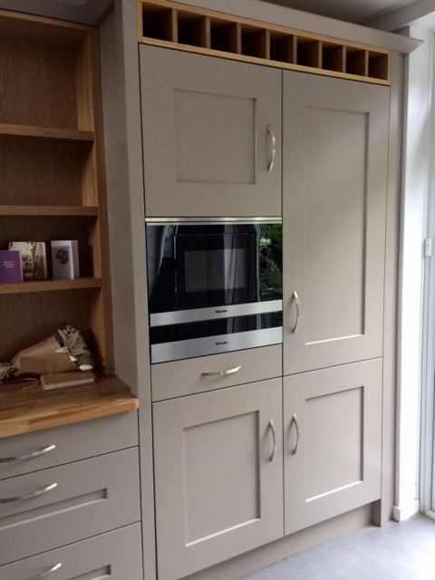 Photo of a medium sized classic enclosed kitchen in Wiltshire with shaker cabinets, wood worktops and no island.
