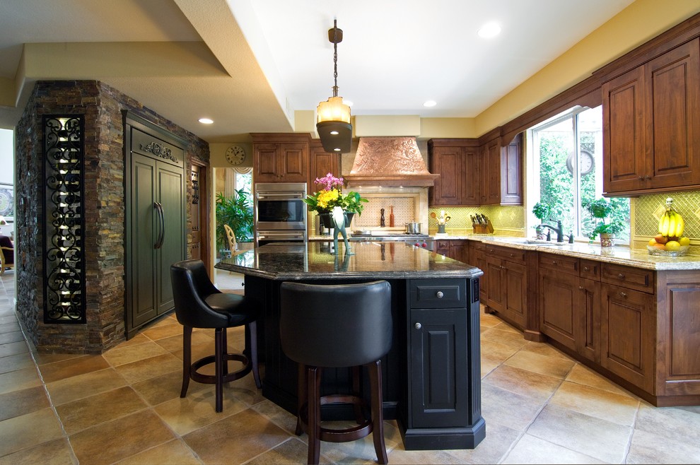 Inspiration for a mid-sized timeless l-shaped ceramic tile and beige floor eat-in kitchen remodel in Orange County with a single-bowl sink, beaded inset cabinets, dark wood cabinets, granite countertops, blue backsplash, mosaic tile backsplash, stainless steel appliances, an island and beige countertops