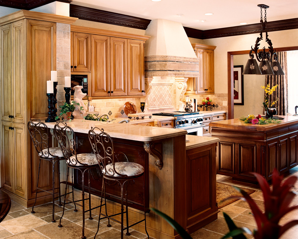Mittelgroße Klassische Wohnküche in L-Form mit profilierten Schrankfronten, hellen Holzschränken, Onyx-Arbeitsplatte, Küchenrückwand in Beige, Rückwand aus Steinfliesen, Küchengeräten aus Edelstahl, Kalkstein und Kücheninsel in Wichita