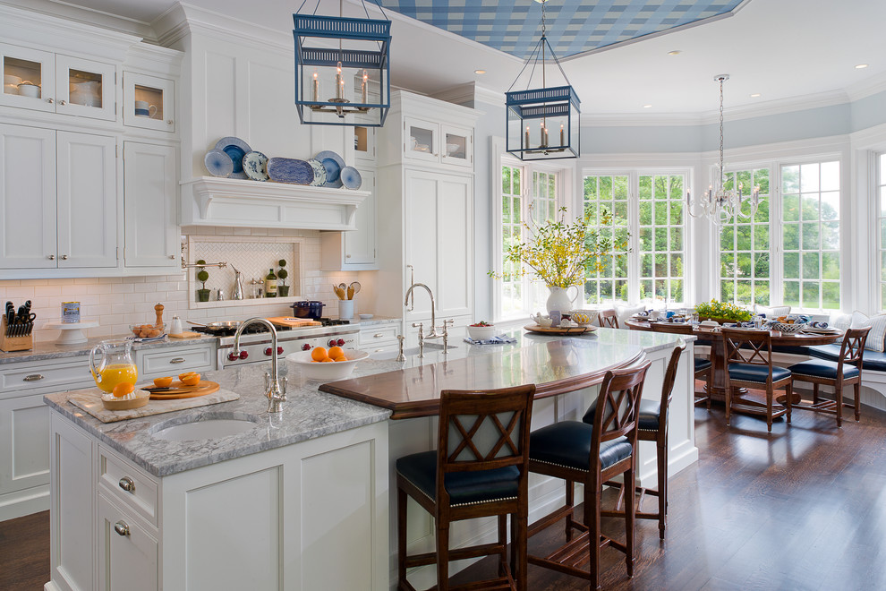 Inspiration for a timeless eat-in kitchen remodel in New York with a farmhouse sink, shaker cabinets, white cabinets, white backsplash, subway tile backsplash and paneled appliances