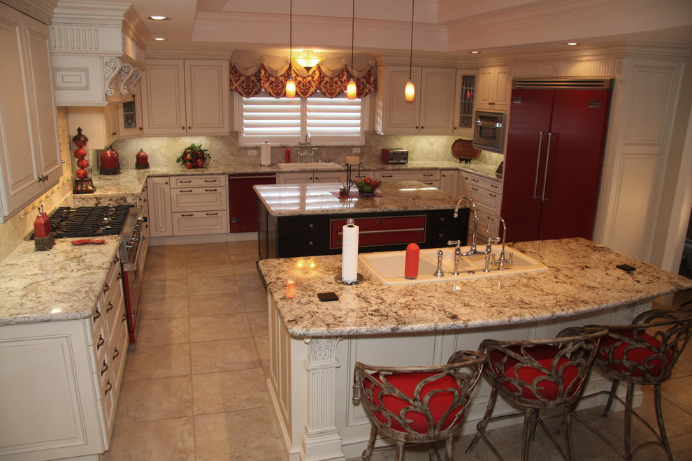 Traditional white kitchen with bright red appliances & accents & carved