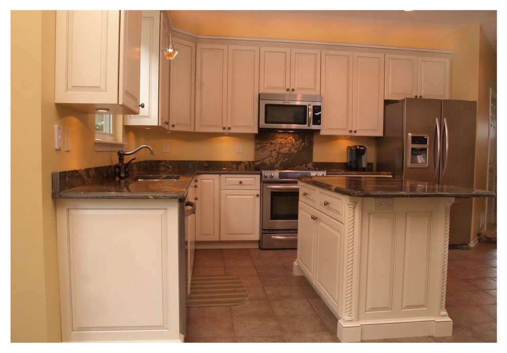 This is an example of a traditional l-shaped kitchen in Baltimore with a submerged sink, raised-panel cabinets, white cabinets, granite worktops, brown splashback, stone slab splashback, stainless steel appliances and an island.