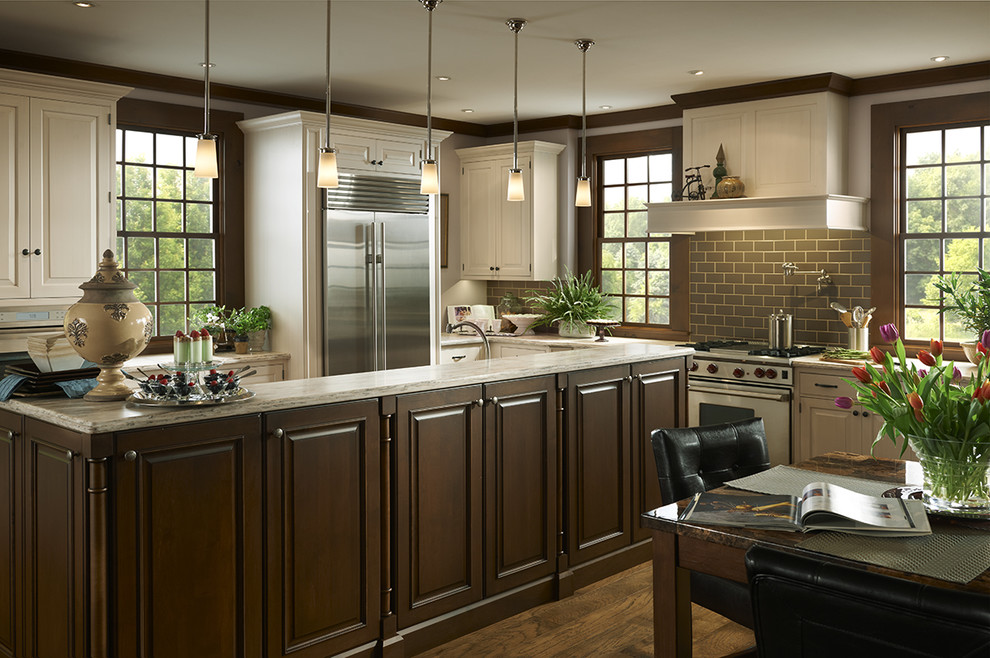 Example of a huge classic single-wall dark wood floor and brown floor open concept kitchen design in Houston with raised-panel cabinets, white cabinets, quartz countertops, brown backsplash, porcelain backsplash, stainless steel appliances, an undermount sink and an island