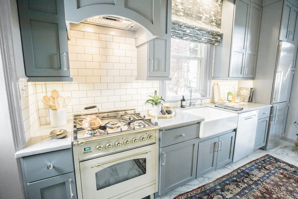 Inspiration for a large eclectic galley marble floor and white floor eat-in kitchen remodel in DC Metro with a farmhouse sink, recessed-panel cabinets, gray cabinets, solid surface countertops, white backsplash, subway tile backsplash, stainless steel appliances, an island and white countertops