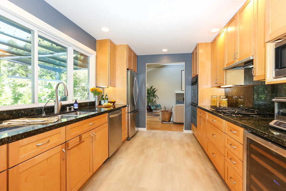 Inspiration for a mid-sized timeless galley ceramic tile eat-in kitchen remodel in San Francisco with a double-bowl sink, shaker cabinets, light wood cabinets, onyx countertops, black backsplash, stone slab backsplash, stainless steel appliances and no island