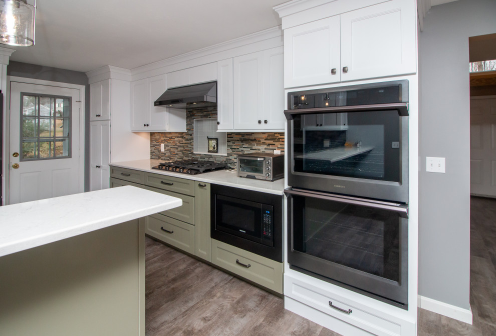 Eat-in kitchen - large traditional u-shaped vinyl floor and gray floor eat-in kitchen idea in Boston with a single-bowl sink, shaker cabinets, white cabinets, quartz countertops, multicolored backsplash, glass sheet backsplash, stainless steel appliances, a peninsula and white countertops