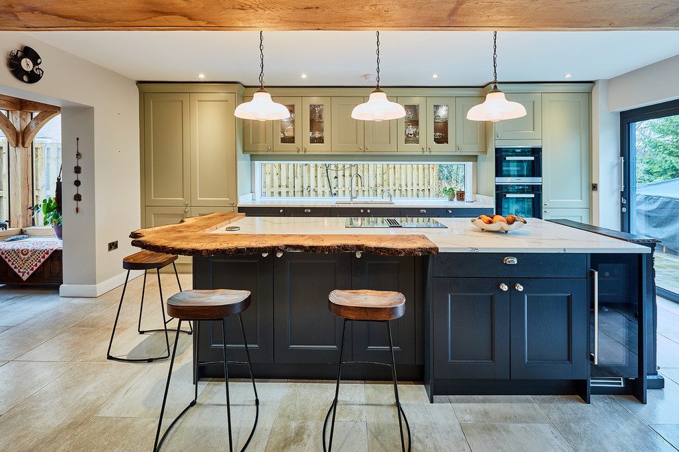 Design ideas for a medium sized classic single-wall open plan kitchen in Other with a built-in sink, shaker cabinets, green cabinets, quartz worktops, white splashback, window splashback, stainless steel appliances, porcelain flooring, an island, beige floors and white worktops.