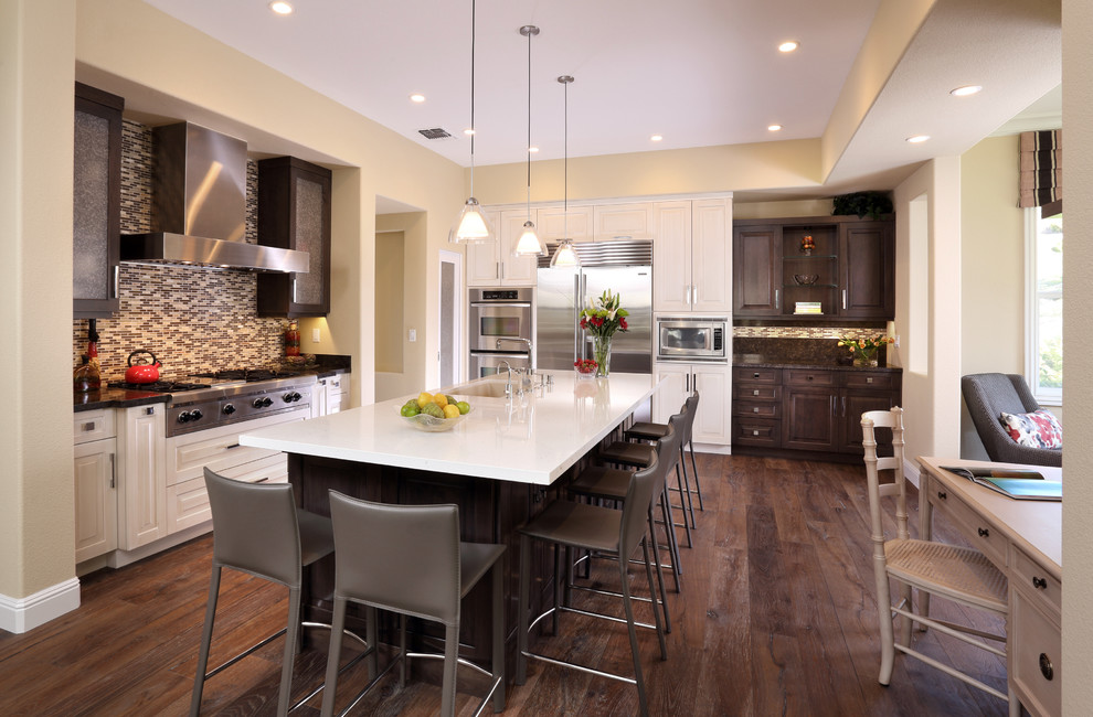 Design ideas for a medium sized classic l-shaped kitchen/diner in San Francisco with brown splashback, mosaic tiled splashback, stainless steel appliances, medium hardwood flooring, an island, a double-bowl sink, shaker cabinets and brown cabinets.