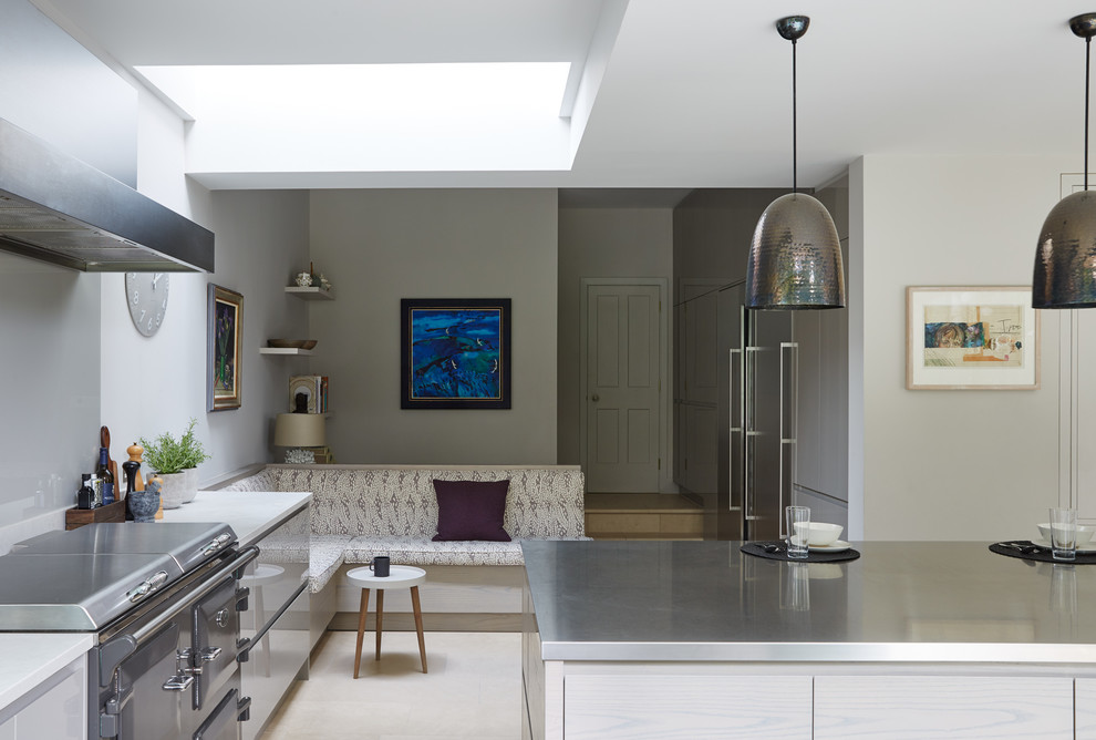 Design ideas for a large contemporary l-shaped open plan kitchen in London with an integrated sink, flat-panel cabinets, beige cabinets, quartz worktops, stainless steel appliances, ceramic flooring, multiple islands, beige floors and white worktops.