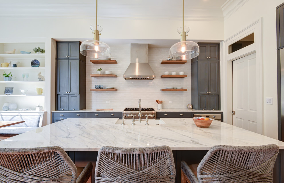 Inspiration for a medium sized classic l-shaped kitchen in New Orleans with a submerged sink, recessed-panel cabinets, blue cabinets, white splashback, stainless steel appliances, medium hardwood flooring, an island and white worktops.