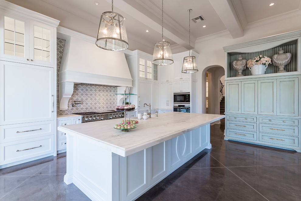 Inspiration for a huge transitional l-shaped brown floor and dark wood floor eat-in kitchen remodel in Phoenix with a farmhouse sink, shaker cabinets, white cabinets, marble countertops, gray backsplash, an island, porcelain backsplash and stainless steel appliances
