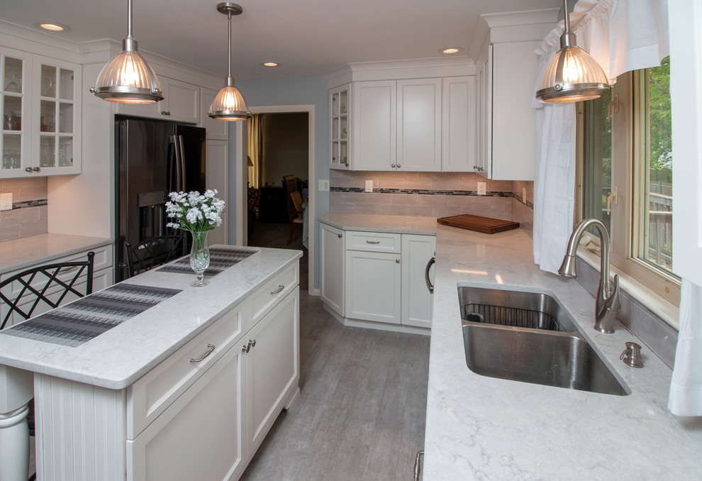 Example of a mid-sized transitional u-shaped vinyl floor and gray floor eat-in kitchen design in Manchester with a double-bowl sink, recessed-panel cabinets, white cabinets, quartz countertops, gray backsplash, ceramic backsplash, stainless steel appliances, an island and white countertops