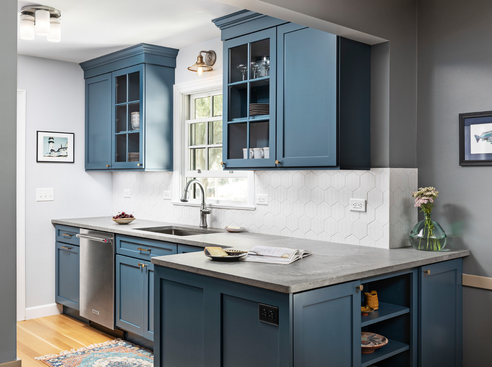 Inspiration for a small nautical galley kitchen/diner in Detroit with a submerged sink, shaker cabinets, blue cabinets, engineered stone countertops, grey splashback, porcelain splashback, stainless steel appliances, light hardwood flooring, no island, brown floors and grey worktops.