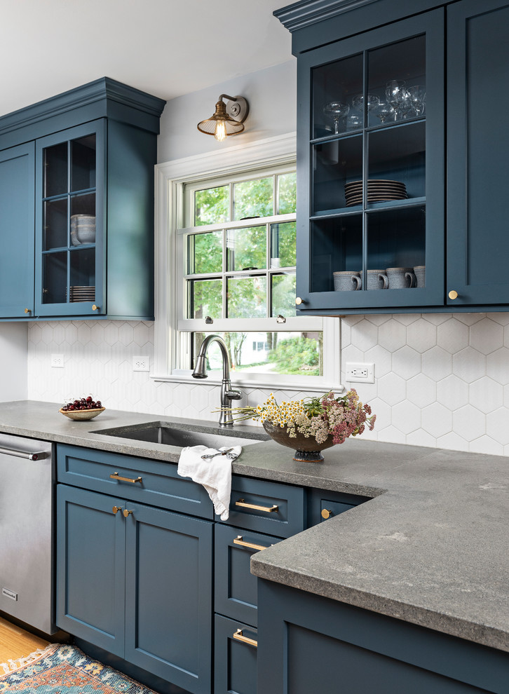 Eat-in kitchen - small coastal galley light wood floor and brown floor eat-in kitchen idea in Detroit with an undermount sink, shaker cabinets, blue cabinets, quartz countertops, gray backsplash, porcelain backsplash, stainless steel appliances, no island and gray countertops