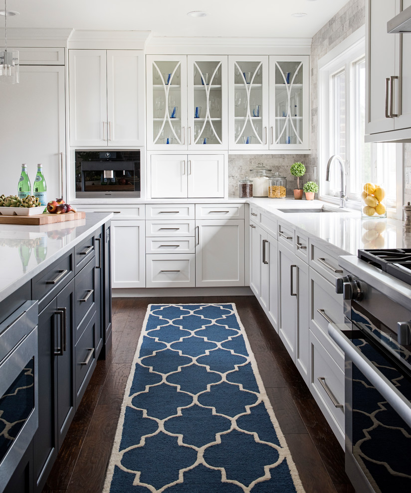 Inspiration for a large traditional l-shaped kitchen/diner in Other with white cabinets, engineered stone countertops, grey splashback, stainless steel appliances, dark hardwood flooring, an island, a submerged sink, shaker cabinets, stone tiled splashback and brown floors.