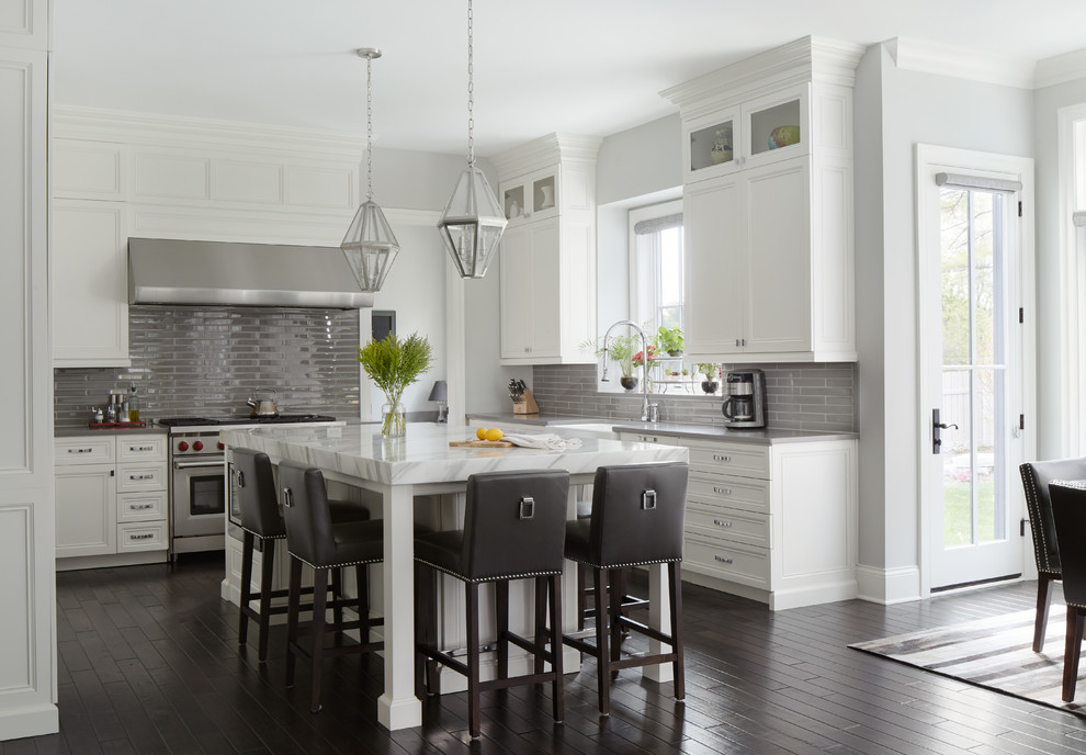 Eat-in kitchen - transitional dark wood floor eat-in kitchen idea in Chicago with recessed-panel cabinets, white cabinets, gray backsplash, stainless steel appliances and an island