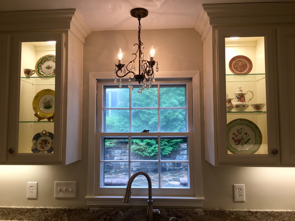 Large cottage chic u-shaped porcelain tile and gray floor eat-in kitchen photo in DC Metro with an undermount sink, raised-panel cabinets, white cabinets, granite countertops, multicolored backsplash, stone slab backsplash, stainless steel appliances and an island