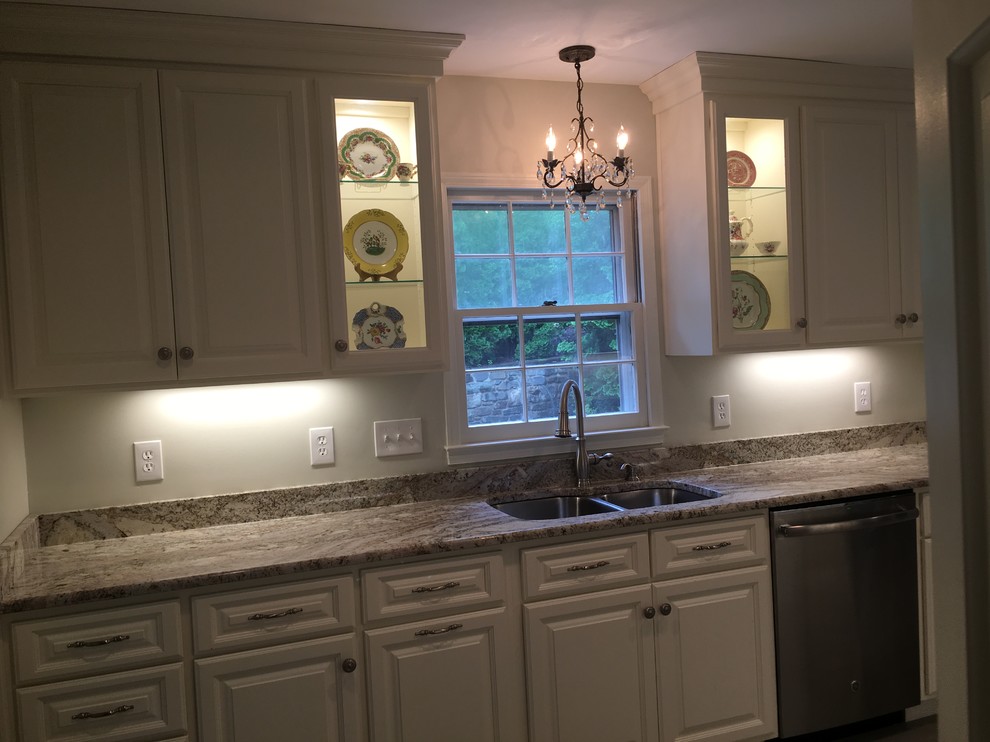 Eat-in kitchen - large shabby-chic style u-shaped porcelain tile and gray floor eat-in kitchen idea in DC Metro with an undermount sink, raised-panel cabinets, white cabinets, granite countertops, multicolored backsplash, stone slab backsplash, stainless steel appliances and an island