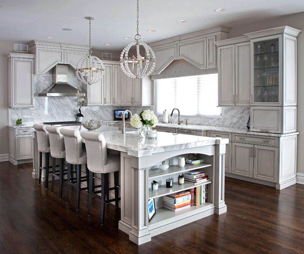 Inspiration for a large transitional u-shaped dark wood floor open concept kitchen remodel in Newark with an undermount sink, raised-panel cabinets, gray cabinets, marble countertops, stone slab backsplash, stainless steel appliances, an island and white backsplash