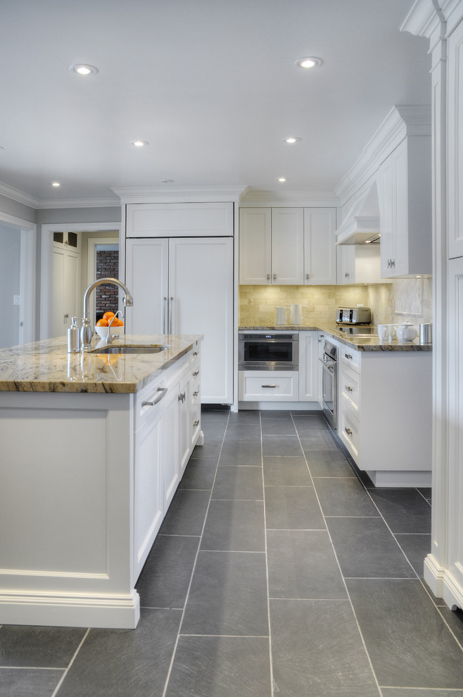 Example of a large transitional l-shaped slate floor eat-in kitchen design in Toronto with an undermount sink, recessed-panel cabinets, white cabinets, granite countertops, paneled appliances and an island