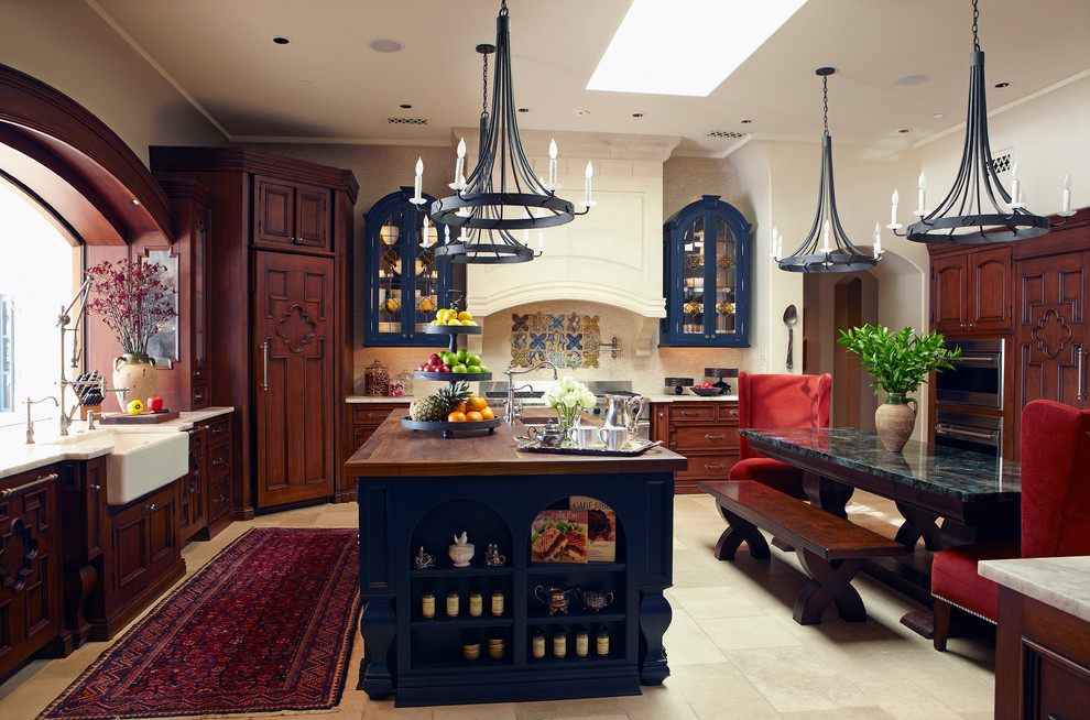 Inspiration for a mediterranean kitchen in Phoenix with recessed-panel cabinets and a belfast sink.