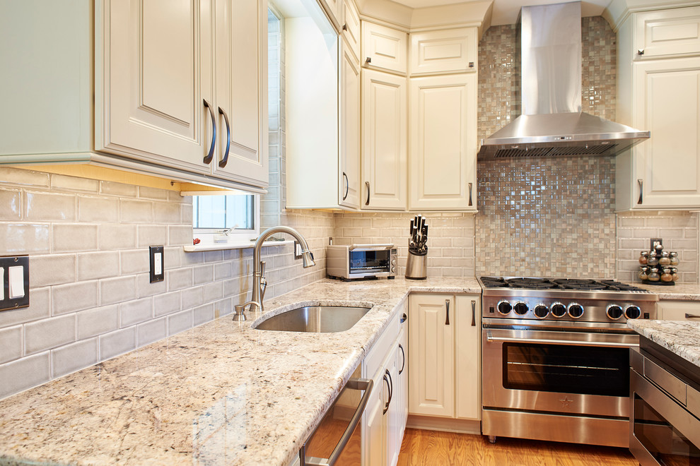 Design ideas for a medium sized traditional l-shaped open plan kitchen in Philadelphia with a submerged sink, raised-panel cabinets, granite worktops, grey splashback, stainless steel appliances and an island.