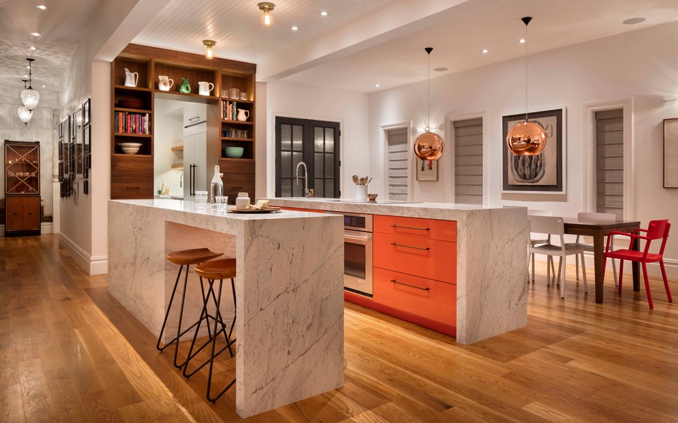 Example of a mid-sized transitional galley medium tone wood floor open concept kitchen design in Denver with two islands, an undermount sink, flat-panel cabinets, marble countertops, stainless steel appliances and medium tone wood cabinets