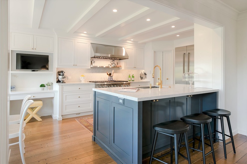 Mid-sized transitional medium tone wood floor eat-in kitchen photo in San Francisco with an undermount sink, shaker cabinets, white cabinets, marble countertops, white backsplash, marble backsplash, stainless steel appliances and a peninsula