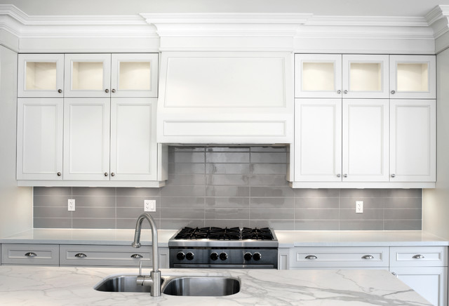 This is an example of a medium sized classic single-wall enclosed kitchen in Toronto with shaker cabinets, white cabinets, laminate countertops, grey splashback, metro tiled splashback, ceramic flooring and an island.