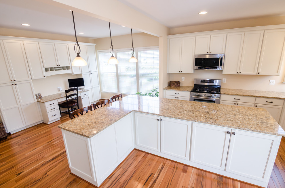 Photo of an expansive classic l-shaped kitchen/diner in DC Metro with an island, recessed-panel cabinets, white cabinets, granite worktops, stainless steel appliances, a submerged sink and medium hardwood flooring.