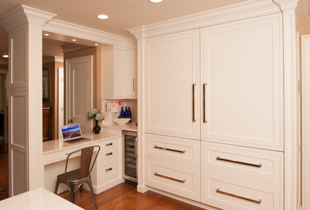 Example of a transitional l-shaped open concept kitchen design in New York with shaker cabinets, beige cabinets, solid surface countertops and stainless steel appliances