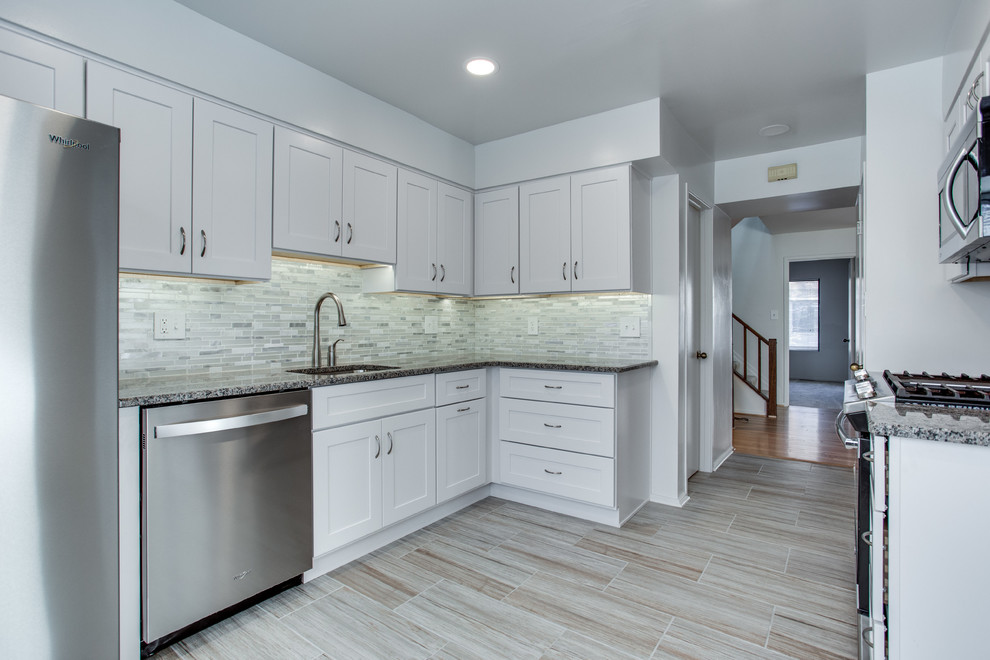 Photo of a medium sized traditional enclosed kitchen in DC Metro with a submerged sink, shaker cabinets, white cabinets, granite worktops and stainless steel appliances.