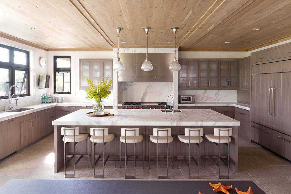 Large transitional u-shaped ceramic tile and beige floor eat-in kitchen photo in New York with a single-bowl sink, flat-panel cabinets, gray cabinets, white backsplash, paneled appliances, marble countertops, stone slab backsplash and an island
