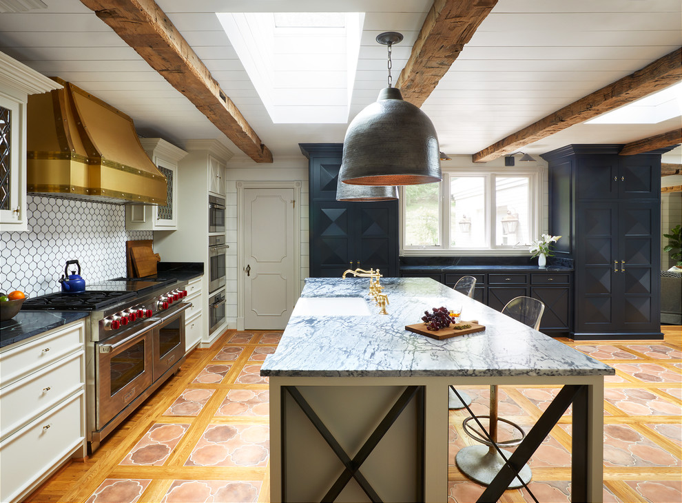 Mid-sized eclectic l-shaped terra-cotta tile and orange floor open concept kitchen photo in Nashville with an undermount sink, recessed-panel cabinets, blue cabinets, quartzite countertops, white backsplash, ceramic backsplash, paneled appliances and an island