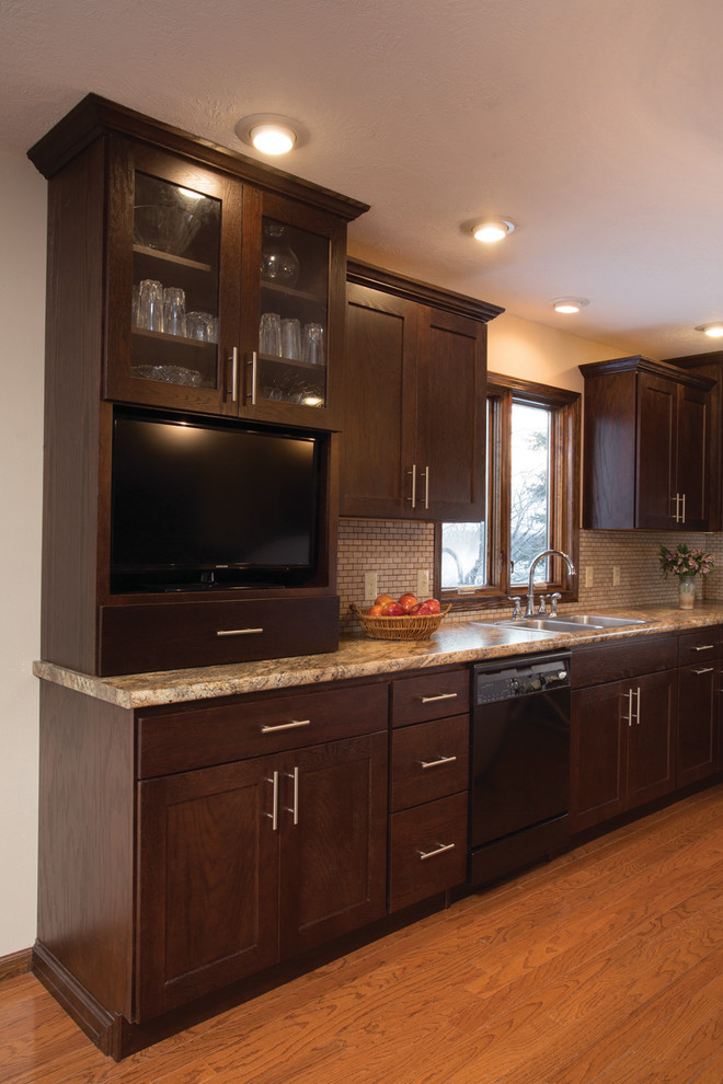 Large transitional u-shaped medium tone wood floor eat-in kitchen photo in Other with recessed-panel cabinets, brown cabinets, stainless steel appliances and an island