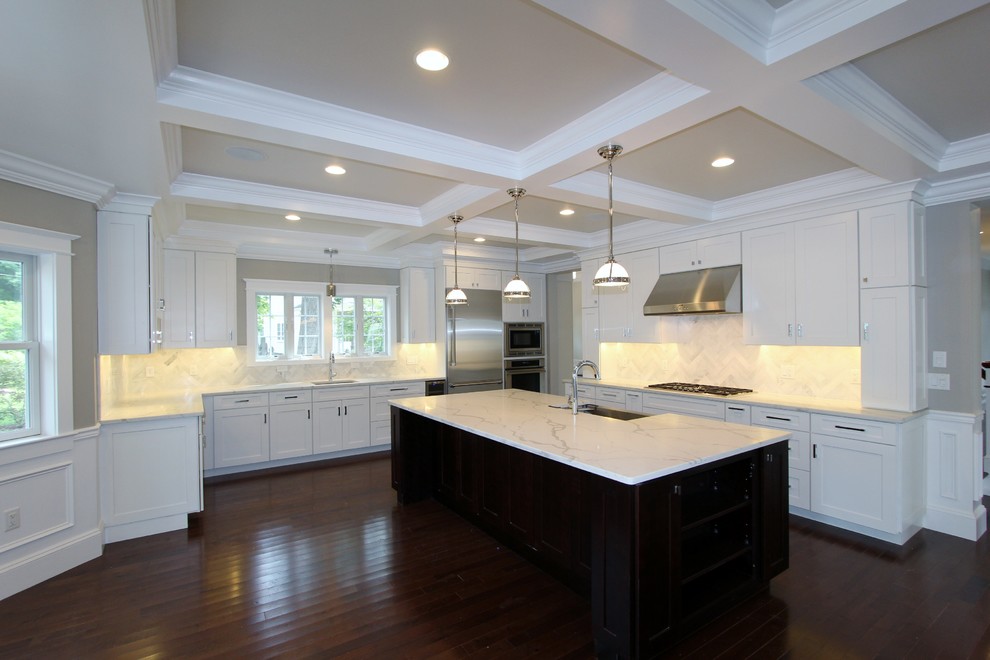 Transitional kitchen in white with a dark island in ...