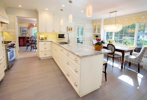 Traditional white kitchen with island cabinets featuring classic brass cup pulls – Timeless Cabinet Handle Styles